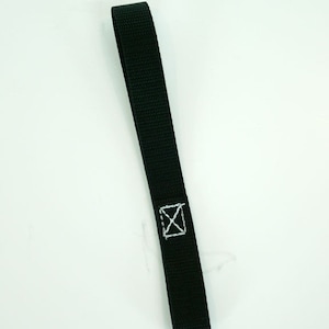 Puede incluir: Correa negra con una X blanca cosida.