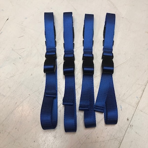 May include: Four blue straps with black plastic buckles. The straps are about 18 inches long.