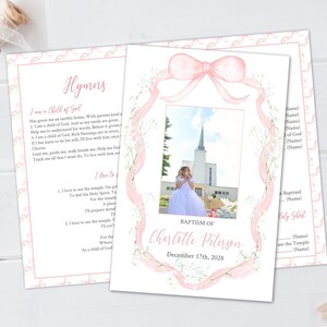 May include: A baptism invitation card with a photo of a child in a white dress in front of a temple. The card has a pink bow and floral design, with the text "Baptism of Charlotte Peterson, December 17th, 2028."
