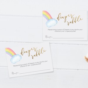 May include: Two white cards with a rainbow and cloud design. The text on the cards reads "diaper raffle". The text below the design reads "Please bring a pack of Diapers in any size for your chance to win a special prize!" There is a blank line for a name.