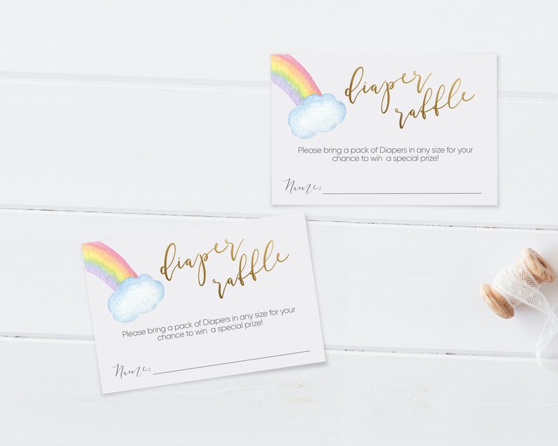 May include: Two white cards with a rainbow and cloud design. The text on the cards reads "diaper raffle". The text below the design reads "Please bring a pack of Diapers in any size for your chance to win a special prize!" There is a blank line for a name.