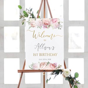 Puede incluir: Un cartel de bienvenida blanco con decoraciones florales rosas y blancas. El cartel dice "Bienvenido a Alison's 1er cumplea&ntilde;os 20 de julio de 2018".