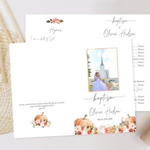 May include: A baptism programme with an autumnal theme. The programme features a photograph of a young girl in a white dress standing in front of a church. The programme also includes a quote from the Bible, "Except a man be born of water and of the Spirit, he cannot enter into the kingdom of God." John 3:5. The programme is decorated with pumpkins, flowers, and leaves.