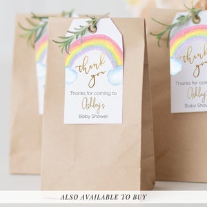 May include: Rainbow baby shower favor tags with the text "thank you" in gold script. The tags feature a watercolor rainbow with clouds and the text "Thanks for coming to Ashley's Baby Shower".