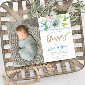 May include: A blue and white striped baby shower invitation with watercolor flowers and gold lettering. The invitation reads "Please join us for the blessing of our son Oliver Williams, Saturday, March 20th, 2022 at two o'clock in the afternoon, 34 Main Street, California, CA. Lunch to follow."