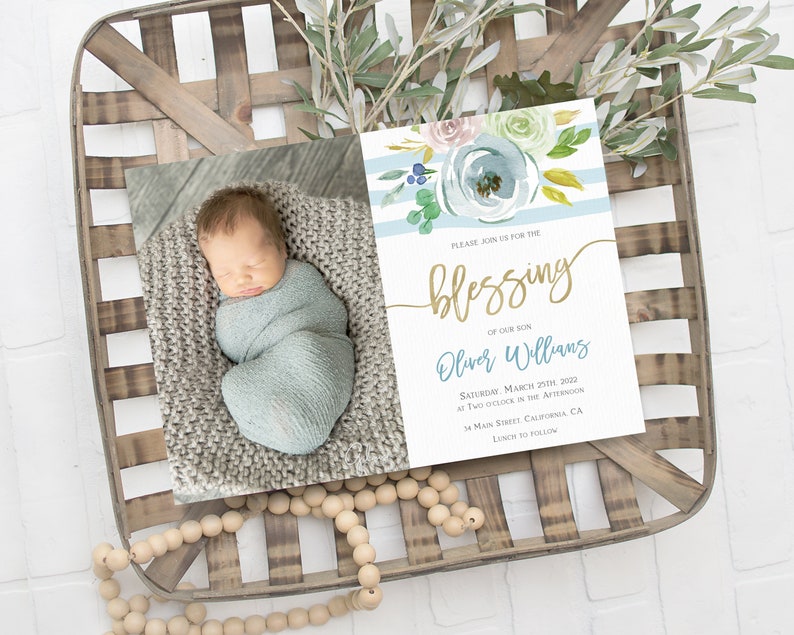 May include: A blue and white striped baby shower invitation with watercolor flowers and gold lettering. The invitation reads "Please join us for the blessing of our son Oliver Williams, Saturday, March 20th, 2022 at two o'clock in the afternoon, 34 Main Street, California, CA. Lunch to follow."