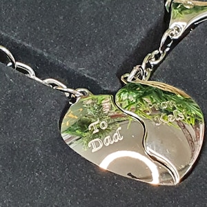 May include: A silver keychain with two heart-shaped charms that fit together. One charm says "To Dad" and the other says "From Kels".