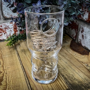 May include: A clear glass Pepsi Max drinking glass with a textured design and the Pepsi Max logo embossed on the side.