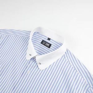 May include: A blue and white striped dress shirt with a white collar. The shirt has a classic design with a button-down front and a small label that reads "77 UNIK". The shirt is made of a lightweight fabric.