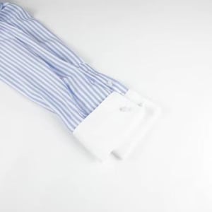 May include: Close-up of a blue and white striped dress shirt sleeve with a white cuff. The cuff has two buttons. The shirt is made of a lightweight fabric and is partially visible on a white background.