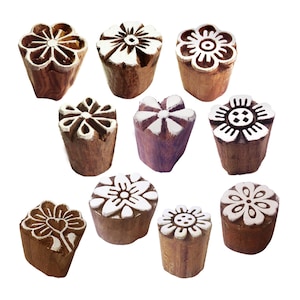 May include: Set of 10 wooden flower block printing stamps. The stamps are made of natural wood and have a variety of floral designs carved into them. The stamps are perfect for creating unique patterns on fabric, paper, and other surfaces.
