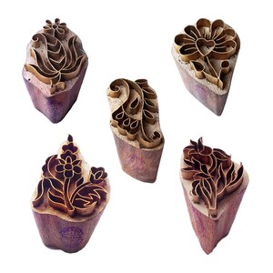 May include: Five wooden printing blocks with brass floral designs. The blocks are used for textile printing and are a traditional craft.