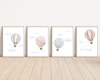 May include: Four framed prints of watercolor illustrations of hot air balloons in various colors, including pink, blue, and gray, with white clouds in the background.