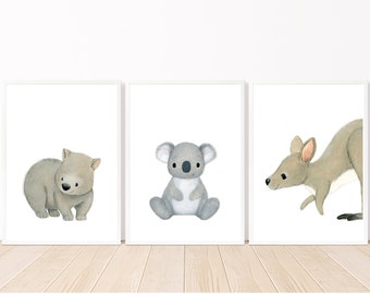 May include: Three framed illustrations of Australian animals. The first shows a wombat, the second a koala, and the third a kangaroo. All three animals are depicted in a cartoon style with soft, muted colors.