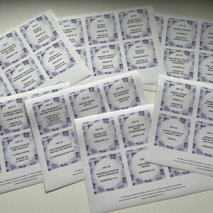 May include: Several sheets of printed cards with a purple and white design. Each card features a title, scripture reference, and the words "Day" followed by a number. The cards appear to be related to prayer or religious study.