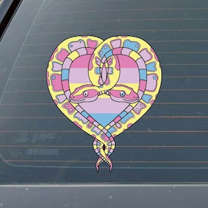 May include: Two yellow, pink, and blue snakes intertwined in a heart shape. The snakes have black eyes and are facing each other. The heart is filled with a pink, blue, and yellow color scheme.