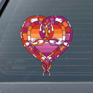 May include: Two snakes intertwined in a heart shape, with the colors of the lesbian pride flag in the background.