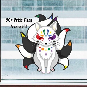 May include: A white fox with nine rainbow tails. The fox has a rainbow face paint design and a rainbow beaded necklace. The text "50+ Pride Flags Available!" is in the top left corner of the image.