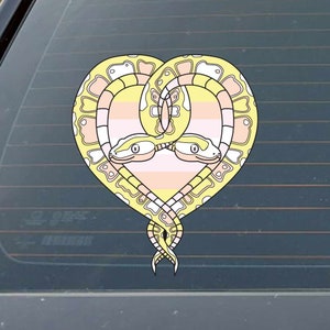 May include: Two yellow and white snakes intertwined in the shape of a heart. The snakes are on a pink, white, and yellow striped background.
