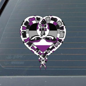 May include: A heart-shaped design featuring two intertwined snakes with a purple, gray, and white color scheme. The snakes are intertwined to form a heart shape, and the colors represent the asexual pride flag.