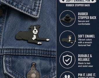 May include: A 1 inch wide soft enamel pin featuring a black and white dog lying down. The pin includes a rubber stopper back. Text on the image reads: 1 inch wide, soft enamel pin, rubber stopper back, secure and comfortable, durable and reliable.