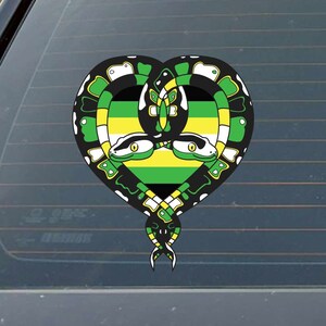 May include: A black, green, and yellow heart-shaped sticker with two snakes intertwined. The snakes have yellow eyes and are facing each other. The snakes are on a green, yellow, and black striped background.