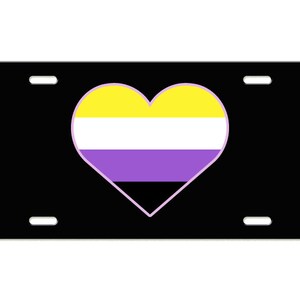 May include: Black license plate with a heart-shaped design in yellow, white, purple, and black colors.