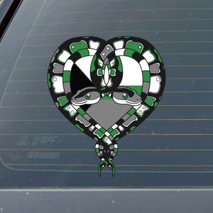 May include: A green, black, and white heart-shaped sticker with two snakes intertwined. The snakes have green and white scales and black eyes. The heart is filled with a green, black, and white pattern.
