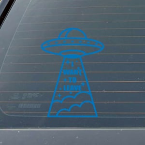 May include: A blue UFO with the text "I WANT TO LEAVE" on a car window.