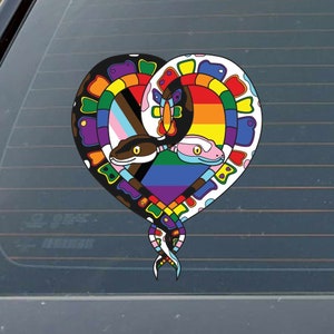 May include: Two snakes intertwined in the shape of a heart. The snakes are colored in the colors of the LGBTQ+ pride flag and the transgender pride flag.