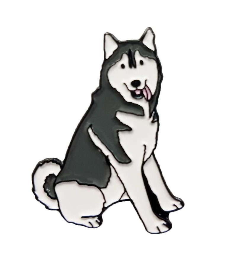 May include: A black and white enamel pin shaped like a sitting Siberian Husky dog. The dog has pointed ears, a curled tail, and a pink tongue sticking out of its mouth. The design features bold black outlines and a smooth, glossy finish.