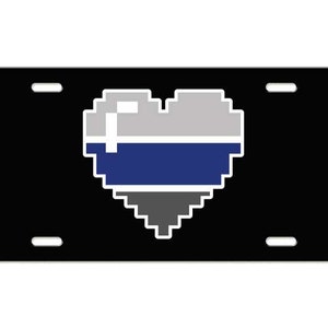 May include: Black license plate with a pixelated heart design in gray, blue, and white.