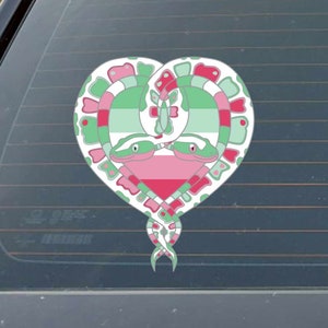 May include: A heart-shaped design featuring two intertwined snakes with green, pink, and white scales. The snakes are forming a heart shape with a green, pink, and white striped pattern inside.