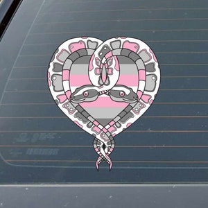 May include: Two snakes intertwined in a heart shape, with pink, gray, and white stripes, representing the gender-neutral pride flag.