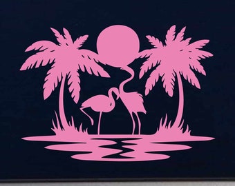 May include: Pink silhouette of two flamingos standing in a lagoon with palm trees and a sun behind them.