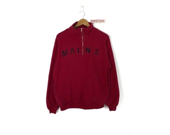 Red fleece Sweater with a Trolley Patch.