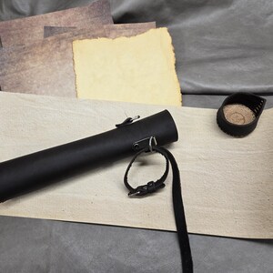 May include: A white ceramic mug with a black handle and the text "But First, Coffee" in a black, handwritten-style font. The mug is on a white surface.