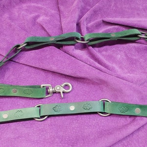 Hand made genuine leather multi ring belt with oak leaf motif in green.