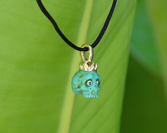 Carved Arizona Turquoise skull with crown 14k gold charm, blue diamonds  eyes .