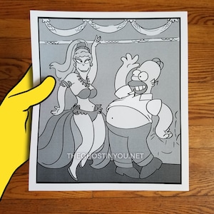 May include: A black and white cartoon image of a man and a woman. The woman is wearing a belly dancing costume and the man is wearing a shirt and pants. The image is from the website "theghostinyou.net".