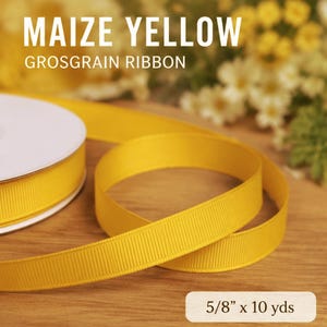 May include: Maize yellow grosgrain ribbon, partially rolled, with a 5/8 inch width and 10 yards length. The ribbon is a bright, solid yellow color. The text "MAIZE YELLOW GROSGRAIN RIBBON" is displayed at the top of the image.