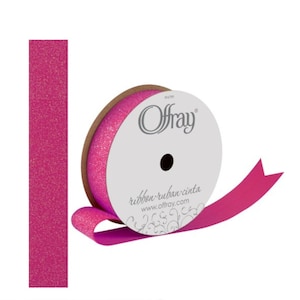 May include: A roll of Offray brand ribbon in a vibrant fuchsia color. The spool has a white label with the brand name and website. A separate strip of the ribbon is shown to the left. The ribbon is ideal for gift wrapping and crafts.