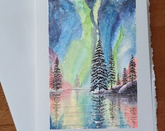 Carte anniversaire Aurore boréale sapins reflets dans l'eau montagnes aux couleurs rose mauve vert bleu carte vœux souhait sans texte