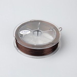 May include: A spool of brown thread wound around a clear plastic bobbin. The bobbin has a label with the text "68468# 9/001".