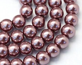 May include: A strand of round, iridescent, mauve-colored glass beads. The beads are smooth and have a pearlescent finish.