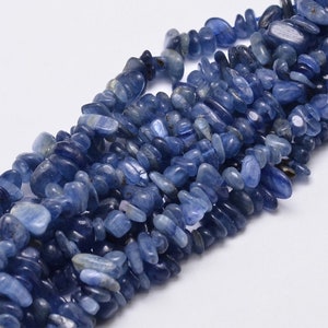 May include: A strand of blue kyanite gemstone beads, each bead is a chip shape with a smooth, polished finish.