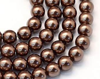 May include: A strand of brown pearl beads. The beads are round and have a smooth, glossy finish.