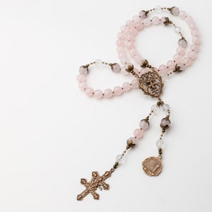 the Saint Joan of Arc rosary is presented on a white background with the five decades loop folded over itself