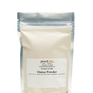May include: A silver resealable pouch containing a white powder labeled "Onion Powder" with the text "pinch spice market" and "Product of USA".