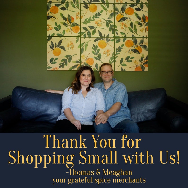 May include: A couple smiles and sits on a dark blue couch in front of a wall with a floral print. The text "Thank You for Shopping Small with Us! -Thomas & Meaghan your grateful spice merchants" is displayed below the couple.